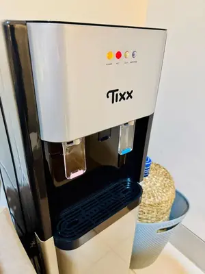 a tiki coffee machine sitting on top of a counter at Cozy Modern Condo in Little Baguio Terraces San Juan City in Manila