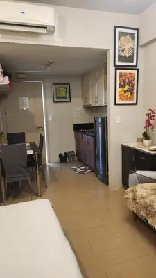 a room with a kitchen and a dining room with a table at Your Home Suite at 150 Newport Boulevard Condo near NAIA T3 in Manila