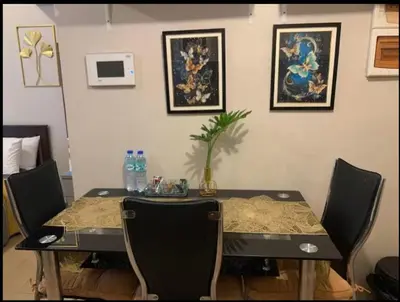 a dining room table with chairs and a table with a tableablish at Your Home Suite at 150 Newport Boulevard Condo near NAIA T3 in Manila