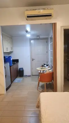 a room with a kitchen and a table with a chair at Your Home Suite at 150 Newport Boulevard Condo near NAIA T3 in Manila