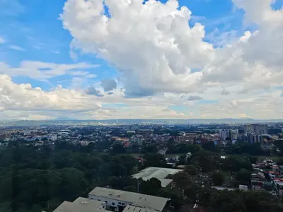 a view of a city under a cloudy sky at Kasara Urban Resort premium studio staycation by Rain in Manila