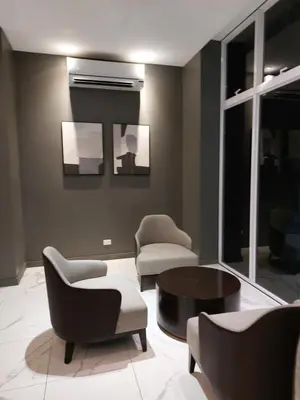 a living room with chairs and a coffee table at Kasara Urban Resort premium studio staycation by Rain in Manila