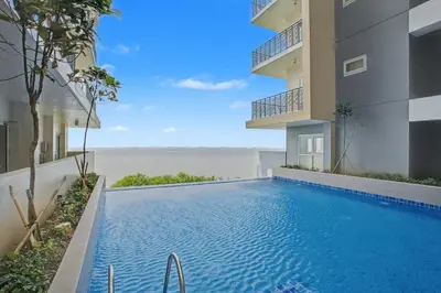 a swimming pool in front of a building at Lovely & Spacious 2BR Home near Solaire & Okada in Manila