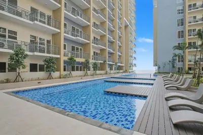 an image of a swimming pool in a building at Lovely & Spacious 2BR Home near Solaire & Okada in Manila