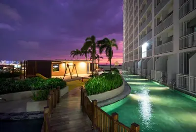 a pool at a hotel at night at CG Staycation Hub in Manila