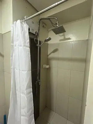 a shower with a shower curtain in a bathroom at CG Staycation Hub in Manila