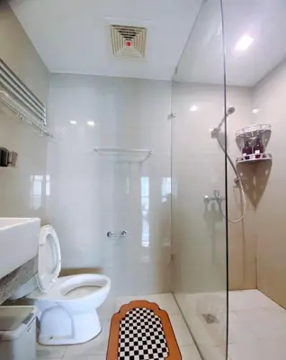 a bathroom with a toilet and a glass shower at 120 Sqm 3Bedrooms Facing Manila Bay Sunset, Airports, Okada, Solaire, MOA, free parking in Manila