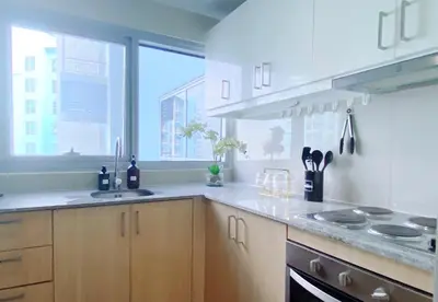 a kitchen with a counter and a sink and a window at 120 Sqm 3Bedrooms Facing Manila Bay Sunset, Airports, Okada, Solaire, MOA, free parking in Manila