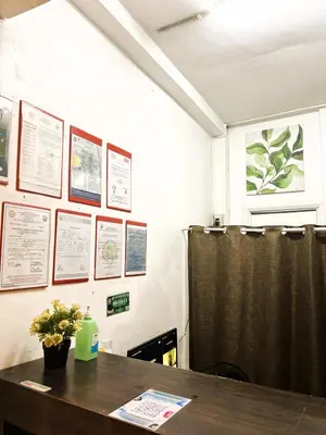 a room with a table and posters on the wall at Makati Avenue Suites in Manila