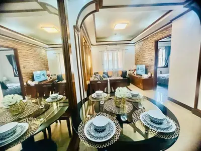 a living room with a glass table in a room at City Condo Perfect for Family & Friends in Manila