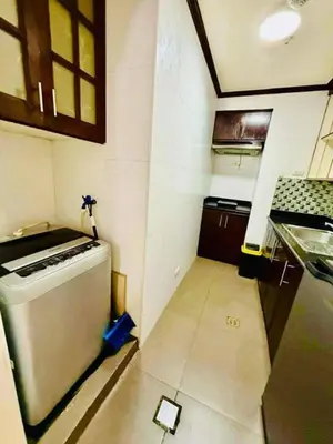 a small kitchen with a stove and a refrigerator at City Condo Perfect for Family & Friends in Manila