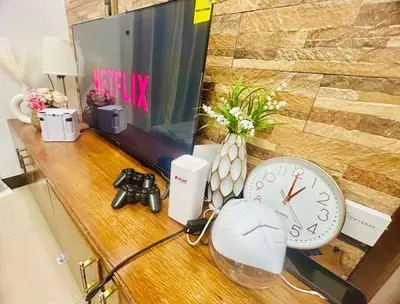 a desk with a clock and a camera on it at City Condo Perfect for Family & Friends in Manila