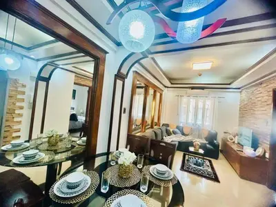 a living room with a table and a couch at City Condo Perfect for Family & Friends in Manila