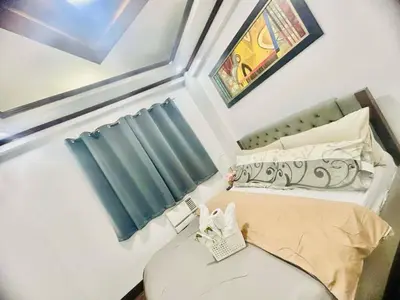 a small bedroom with a bed and a window at City Condo Perfect for Family & Friends in Manila
