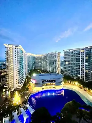 a large building with a pool in front of some buildings at Staycation Condotels RD in Manila