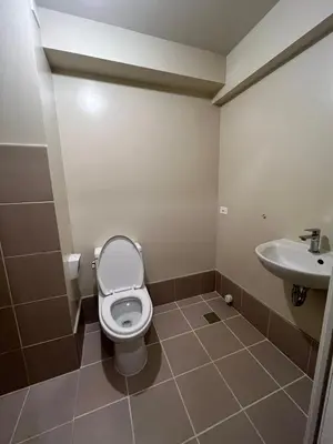 a bathroom with a toilet and a sink at Staycation Condotels RD in Manila