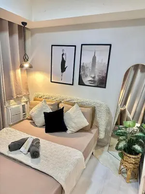 a living room with two beds and a couch at Staycation Condotels RD in Manila