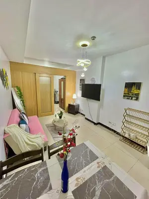 a living room with a couch and a table at MD staycation in Manila