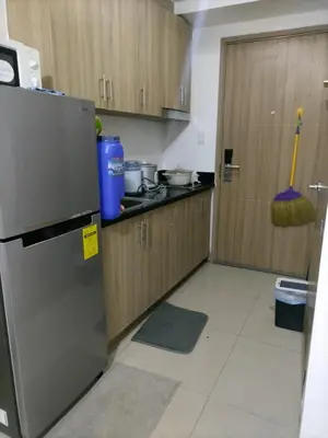 a kitchen with a stainless steel refrigerator and a door at Metro Nest Inn in Manila