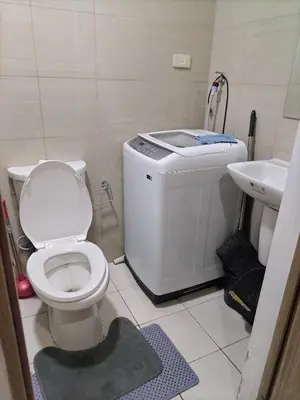 a bathroom with a toilet and a sink at Metro Nest Inn in Manila