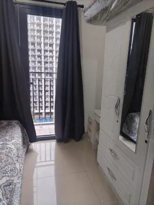 a bedroom with a bed and a large window at Metro Nest Inn in Manila