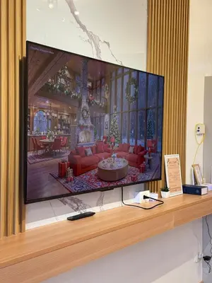a flat screen tv sitting on top of a shelf at Stunning 41F Skyline View Relaxing City Escape in Manila