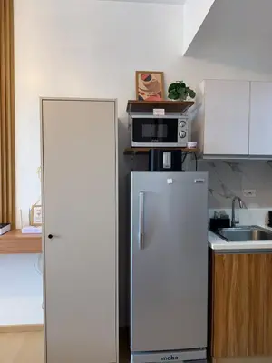 a kitchen with a refrigerator and a microwave at Stunning 41F Skyline View Relaxing City Escape in Manila