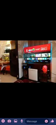 a room with a television and a table with avertisement at JC Palace Residences in Manila