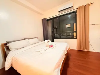 a bedroom with a bed with a towel on it at Malate Bayview Mansion City View and Seaview in Manila
