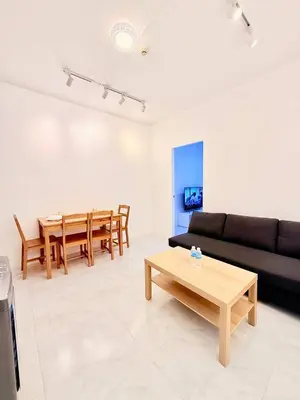 a living room with a couch and a table at Malate Bayview Mansion City View and Seaview in Manila