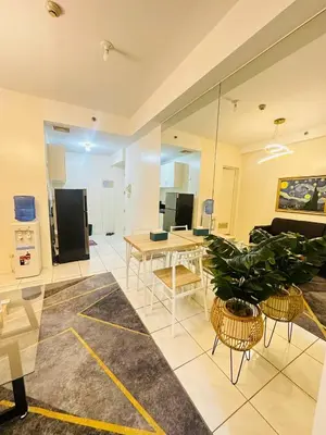 a living room with a couch and a table and chairs at Malate Bayview Mansion City View and Seaview in Manila