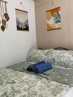 a bed with a blanket and a blue towel on it at Sea Residences Staycation Moa ,Stern Homes in Manila