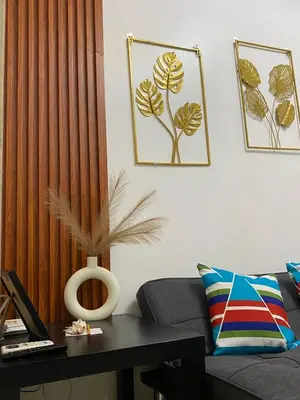 a living room with a couch and a table at Sea Residences Staycation Moa ,Stern Homes in Manila