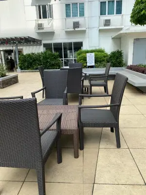 a group of chairs and tables in a patio at Sea Residences Staycation Moa ,Stern Homes in Manila