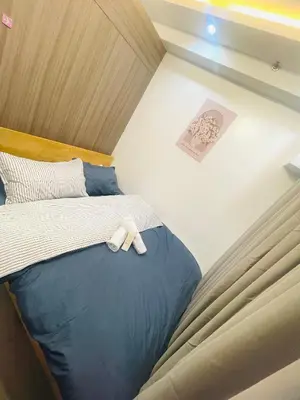 a small bed with a white teddy bear on it at H&M staycation SHORE 2 in Manila