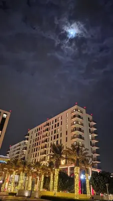 a large building with the moon in the sky at The Shore Luxe Suite in Manila