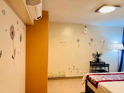 a bedroom with flowers painted on the wall at Easyworld One Uptown Residence BGC in Manila
