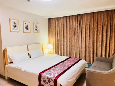 a hotel room with a bed and a chair at Easyworld One Uptown Residence BGC in Manila