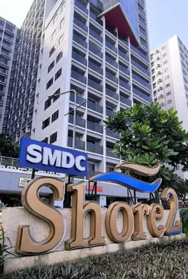 a large sign in front of a large building at Shore2 Moa ph stay in Manila