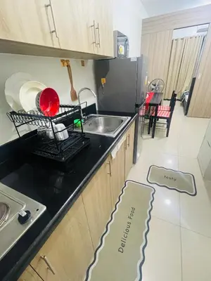 a kitchen with a sink and a counter top at Shore2 Moa ph stay in Manila