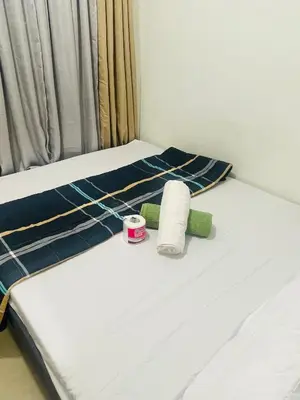 a bed with two mattresses and a roll of toilet paper at Shore2 Moa ph stay in Manila