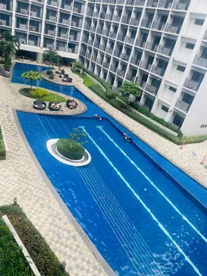 an overhead view of a swimming pool in front of a building at Shore2 Moa ph stay in Manila