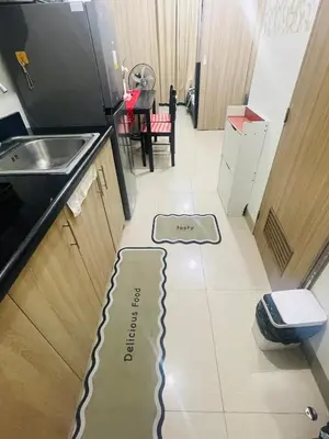 a kitchen floor with a phone on the floor at Shore2 Moa ph stay in Manila