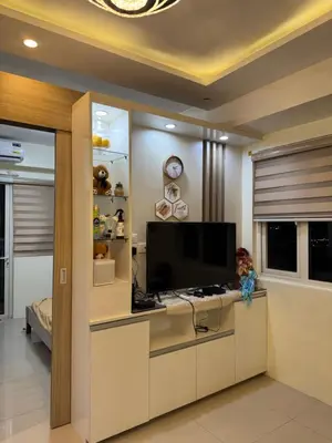 a living room with a flat screen tv in a room at Shore Homestay in Manila