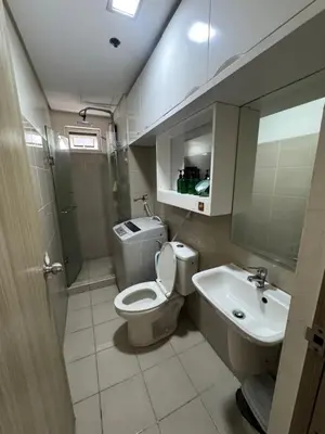 a bathroom with a toilet and a sink at Shore Homestay in Manila