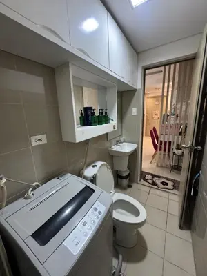 a small bathroom with a toilet and a sink at Shore Homestay in Manila