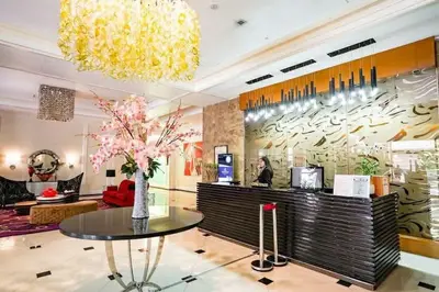 a lobby of a store with a table and flowers at Stamford Executive Residence a2 shortwalk Venice Canal mall in Manila