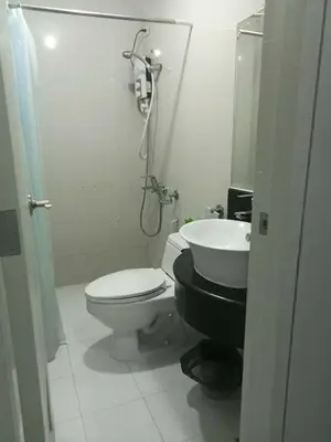 a bathroom with a toilet and a sink at Stamford Executive Residence a2 shortwalk Venice Canal mall in Manila