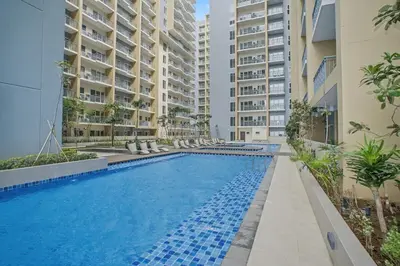 a swimming pool in front of some apartment buildings at Luxury Home near Solaire and Okada Manila in Manila
