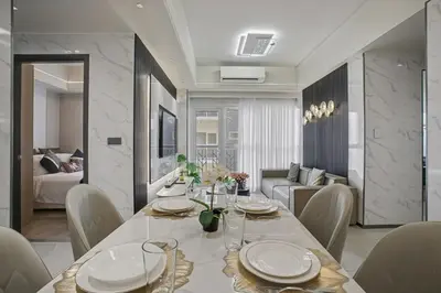 a dining room and living room with a table and chairs at Luxury Home near Solaire and Okada Manila in Manila